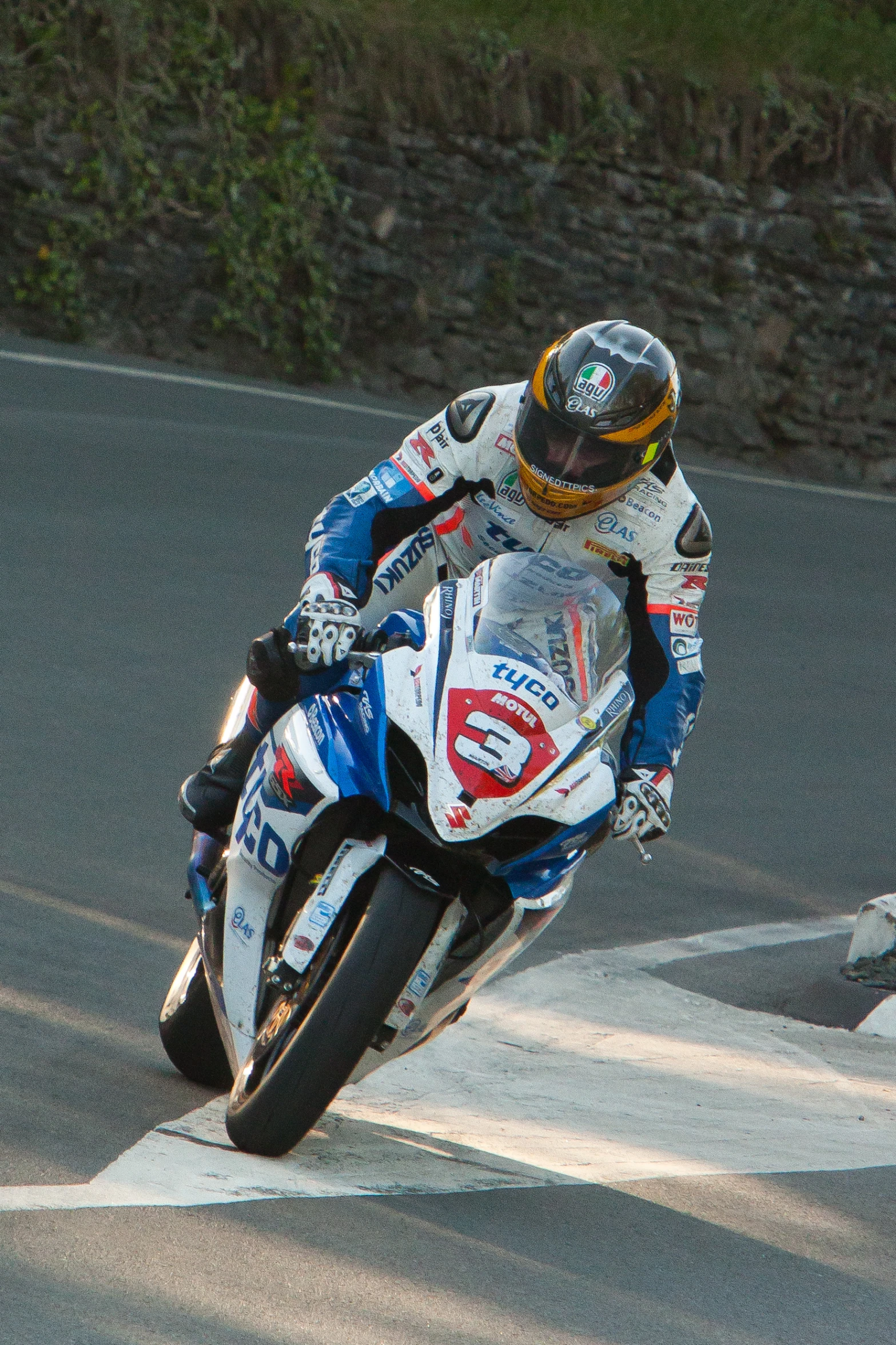 the motorcycle rider is wearing blue and white