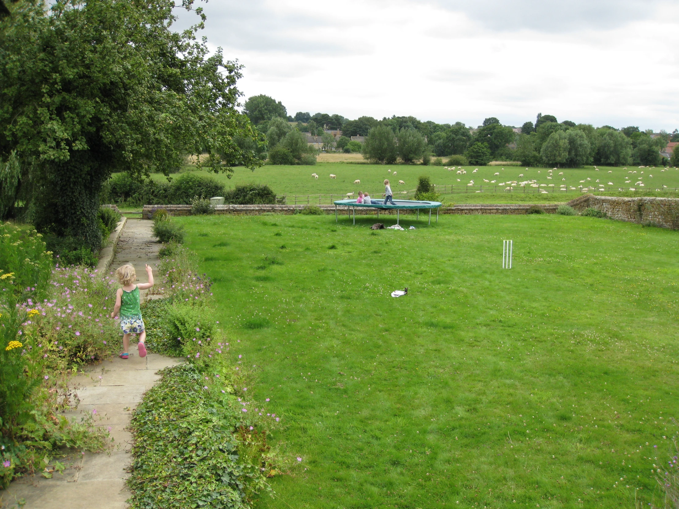 a child throwing soing in a field of grass