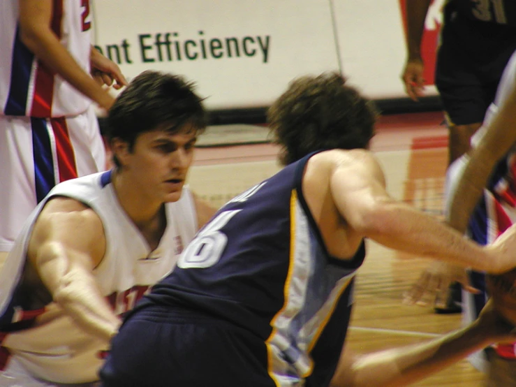 a basketball player reaches out to pass the ball