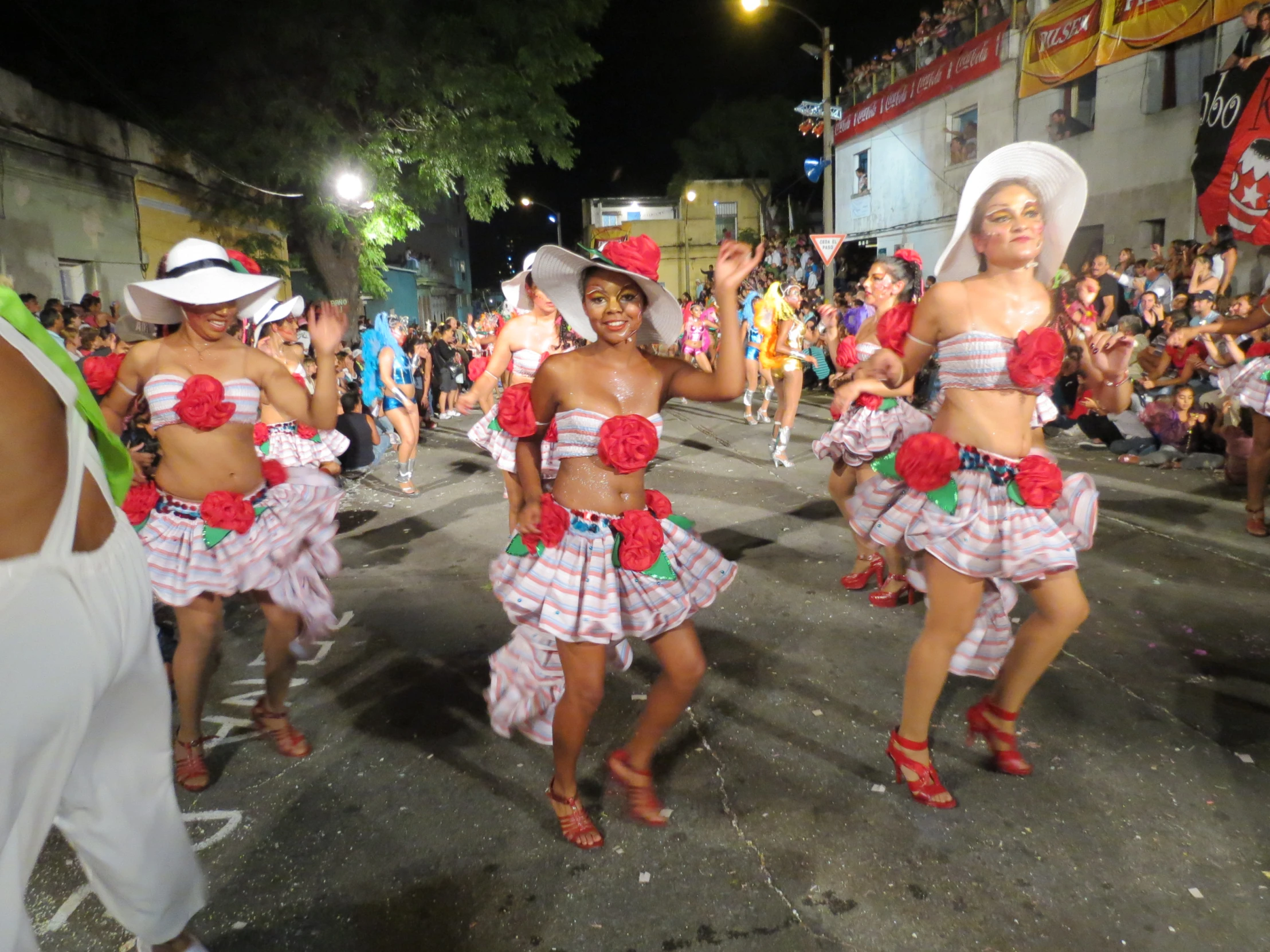 some people dressed in bikinis walking down a street