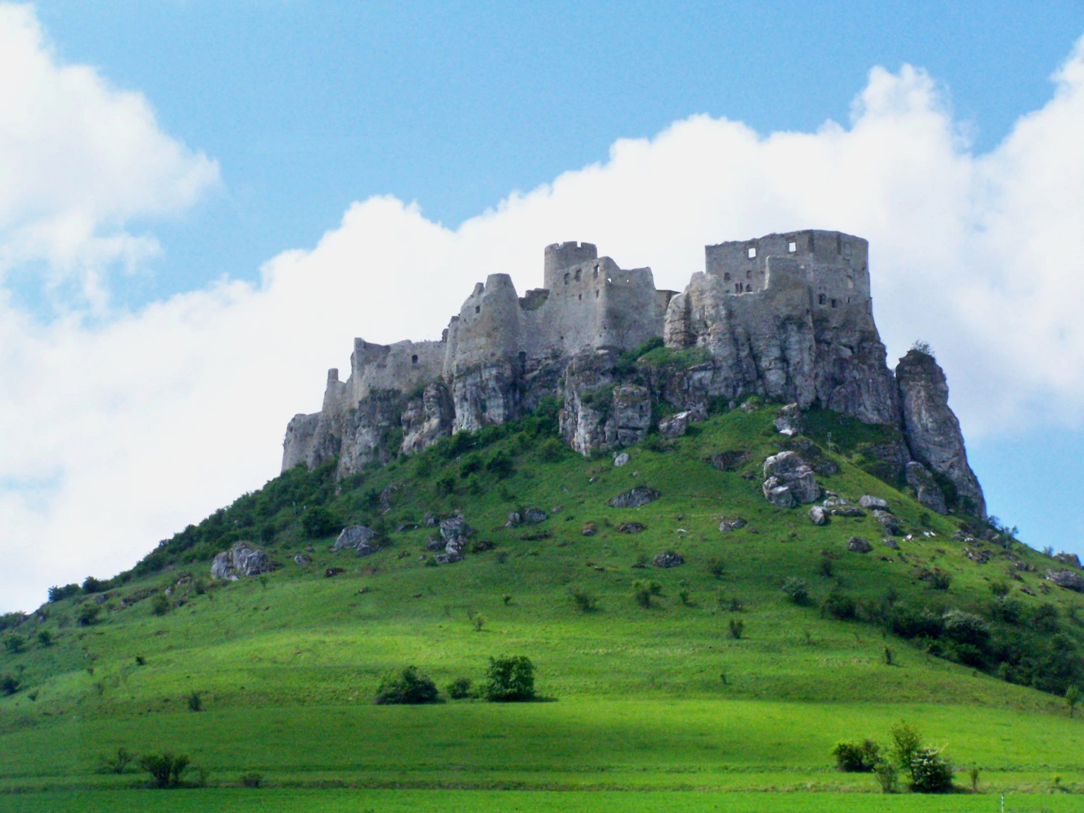 a big mountain with a castle on top