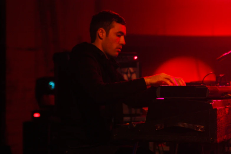 man playing on a keyboard at a concert