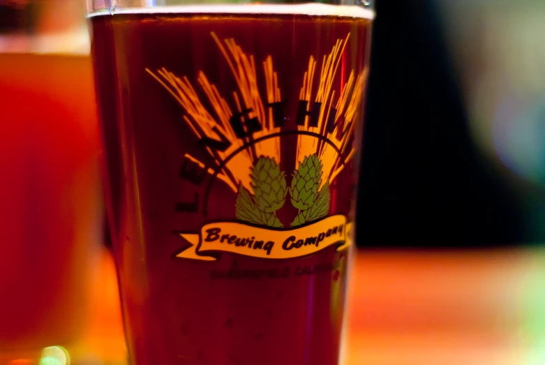 a beverage on a table with wheat and beer