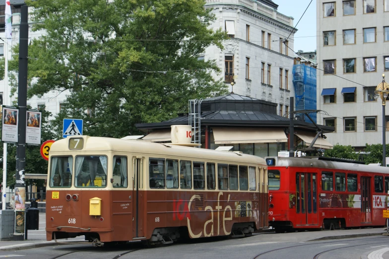 a train that is on the tracks in front of some buildings