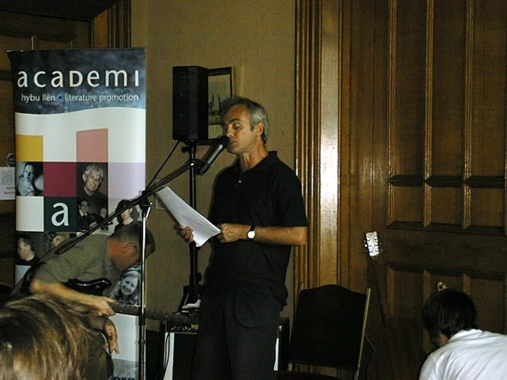 a man standing in front of a microphone