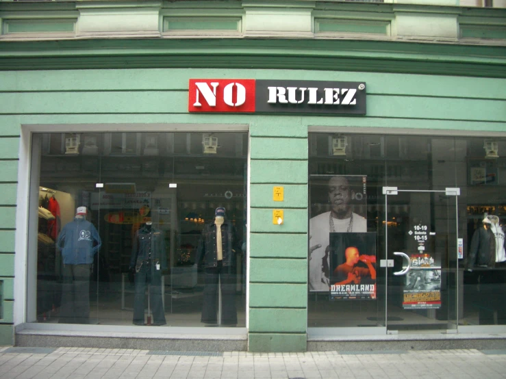 the front entrance of a clothing store with two mannequins