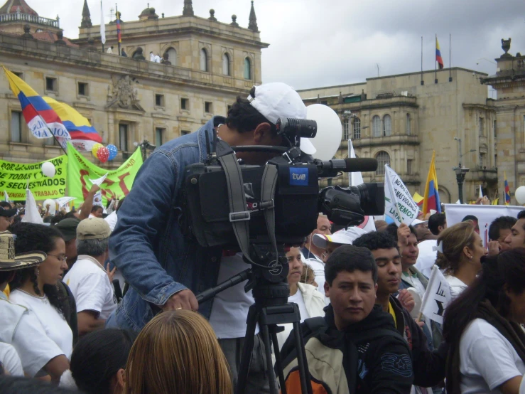 a large group of people gathered in front of an old building