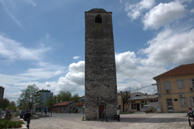 a large stone clock tower on a city street