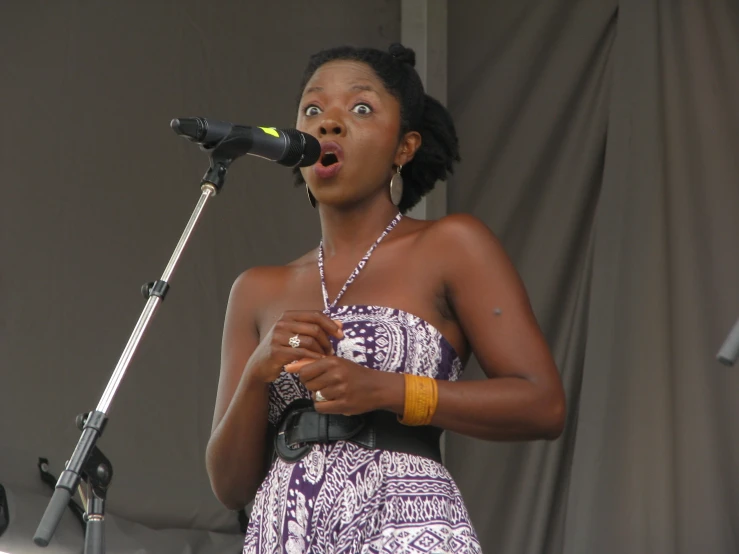 a beautiful young lady standing on top of a stage