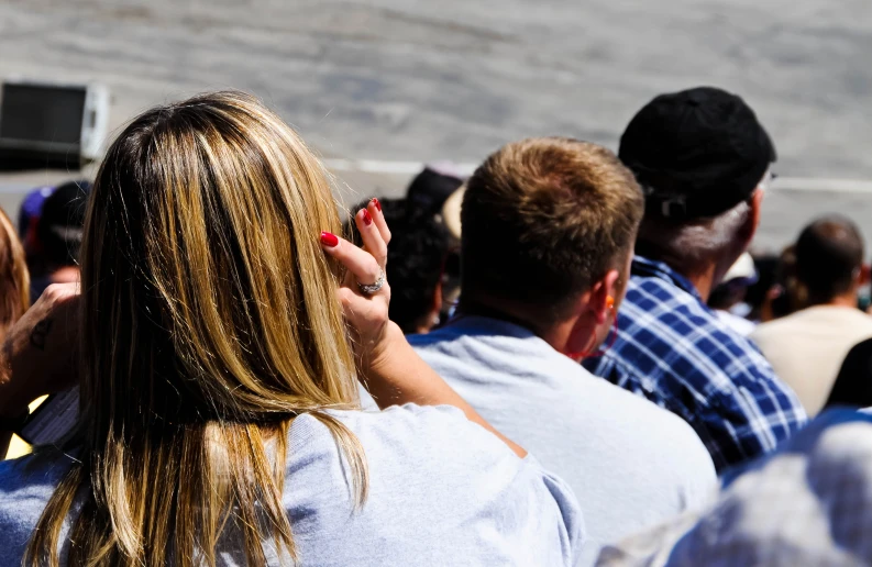 a large group of people watching a woman speak