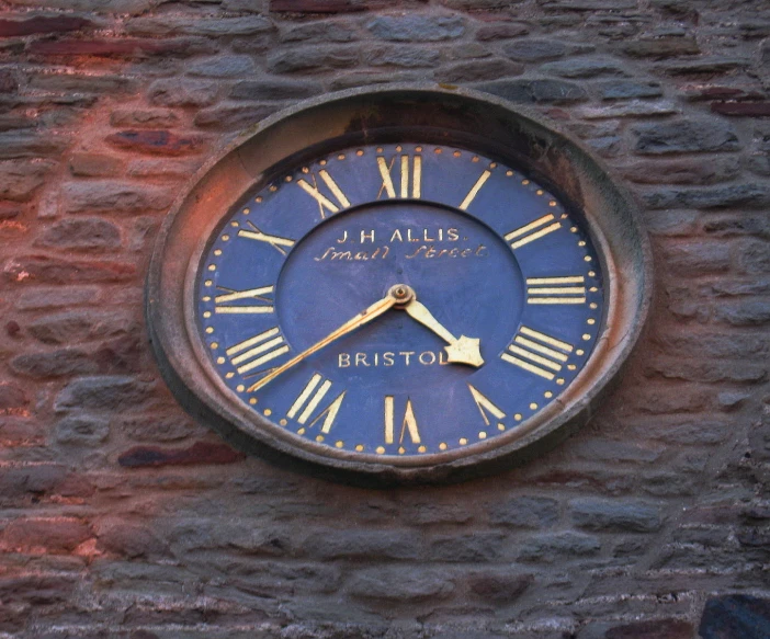 a close up of a clock on the side of a wall