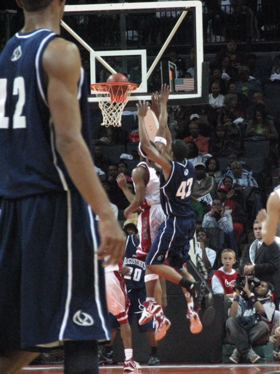 some basketball players are taking a s at the hoop