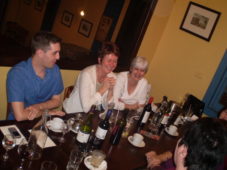 a group of people sitting around a wooden table