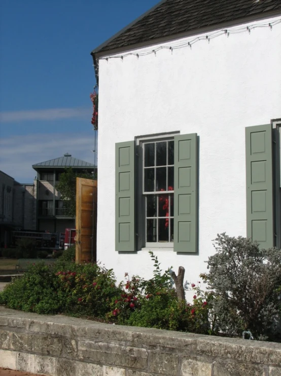 a white house with shutters on the windows