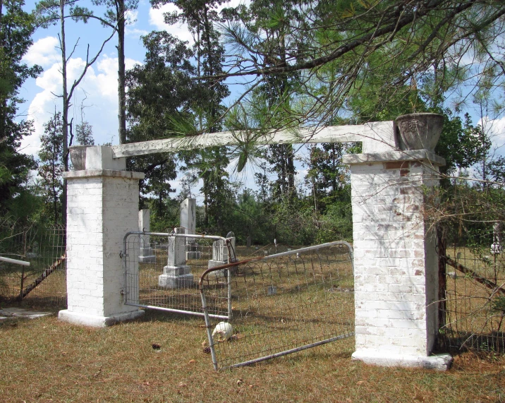 a fence and a gate on a grass covered ground