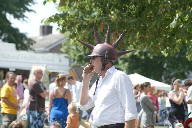 man with horned helmet standing by the trees