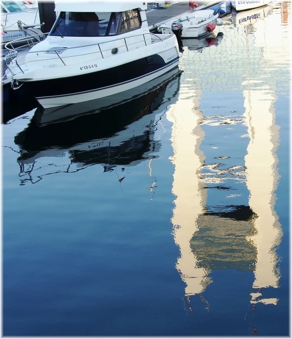 a boat floating on top of water near other boats