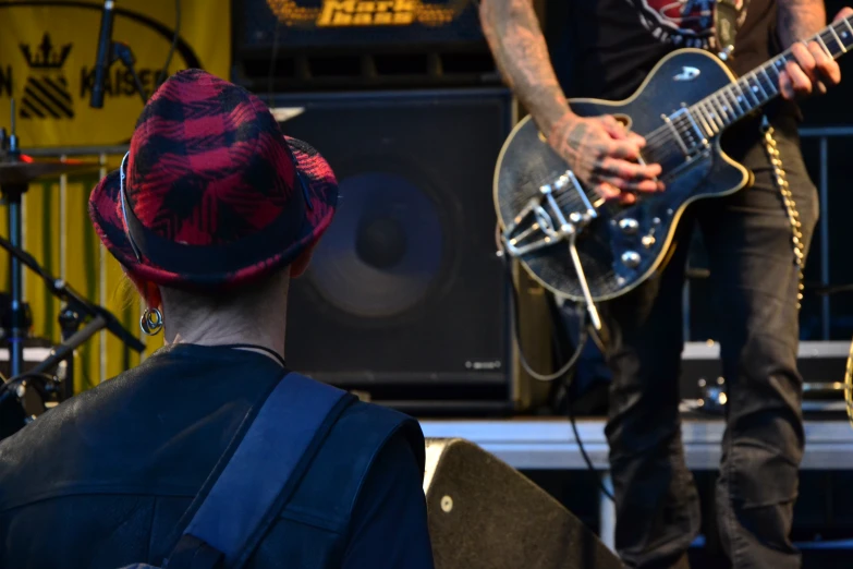 a man plays guitar at an outdoor concert