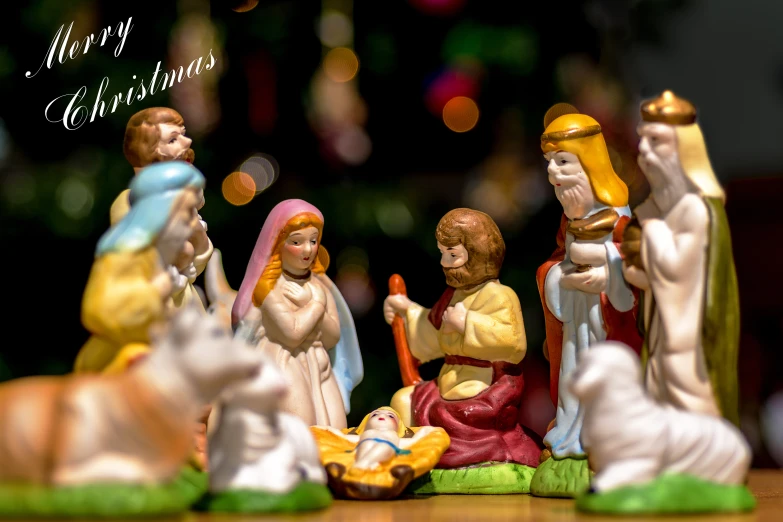 several nativity figurines sit around a table