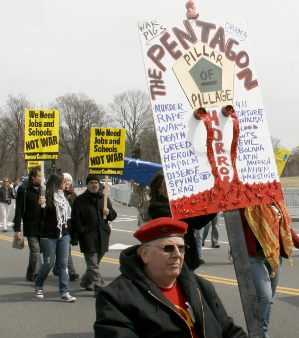 people marching in a protest with political signs