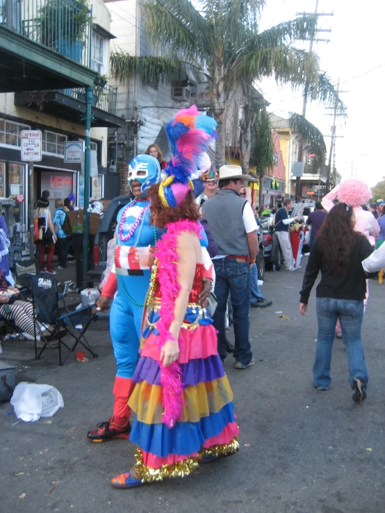 people in costumes and face masks on a city street