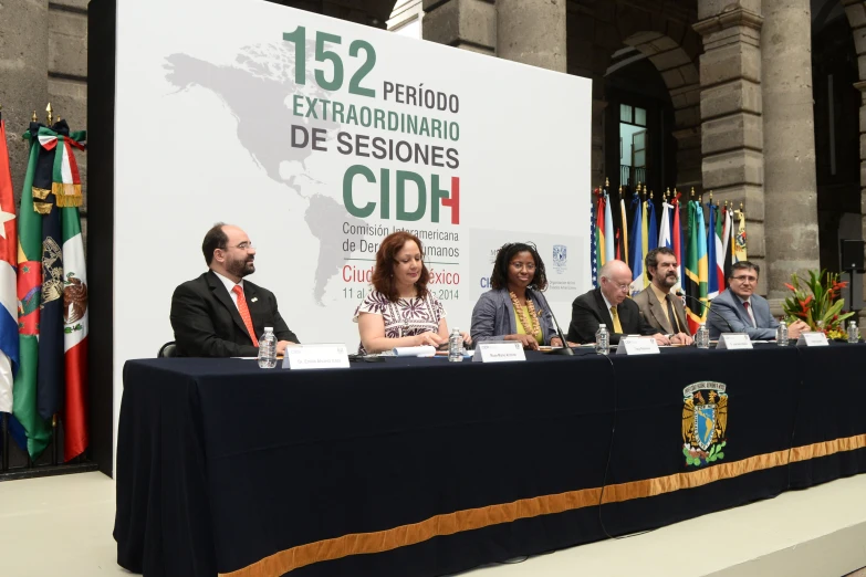 panelists sitting at a table with microphones