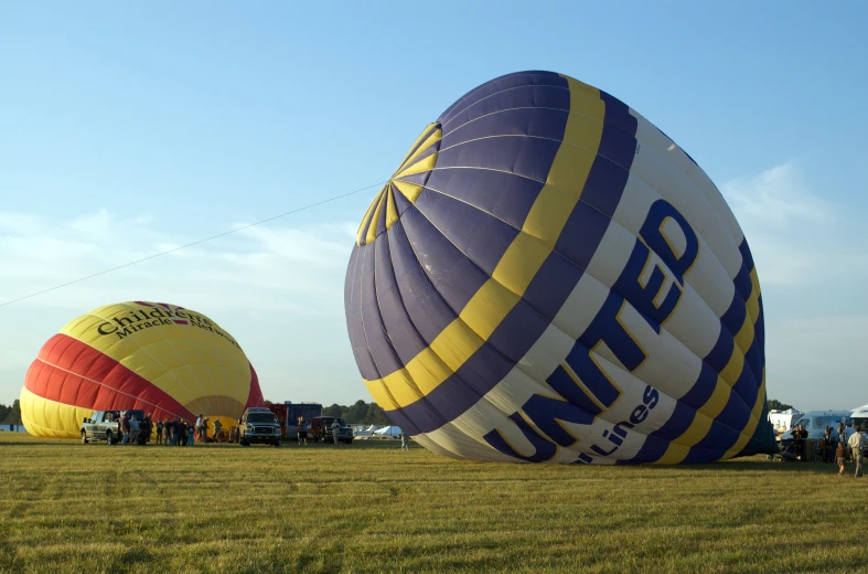 two large balloons sitting on top of a field