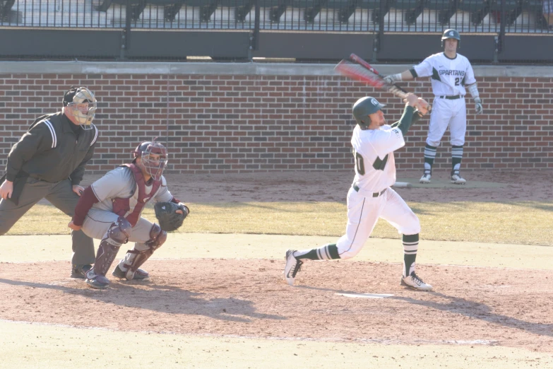 a batter swings his bat during a baseball game