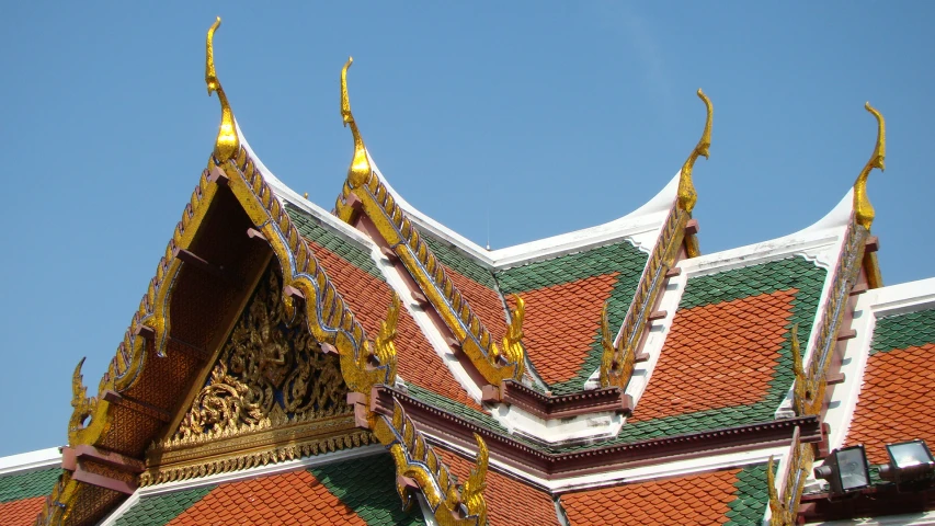 a white, red and yellow building with gold spires