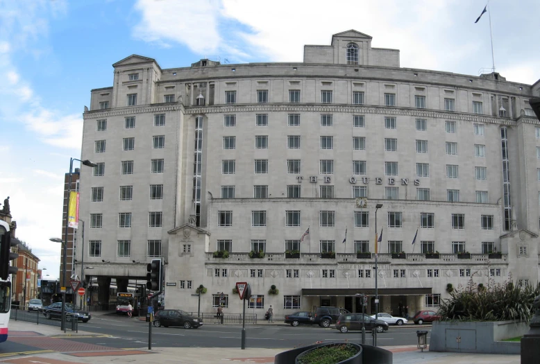 a grey building that has windows near the road