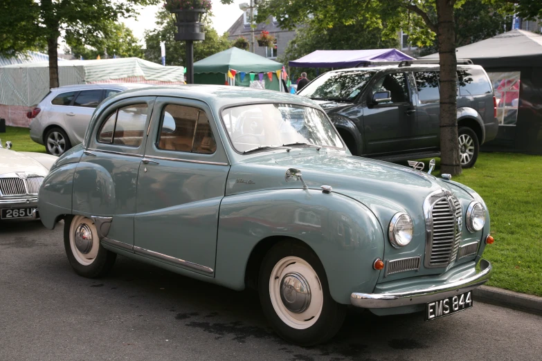 this old car is parked on the side of the road