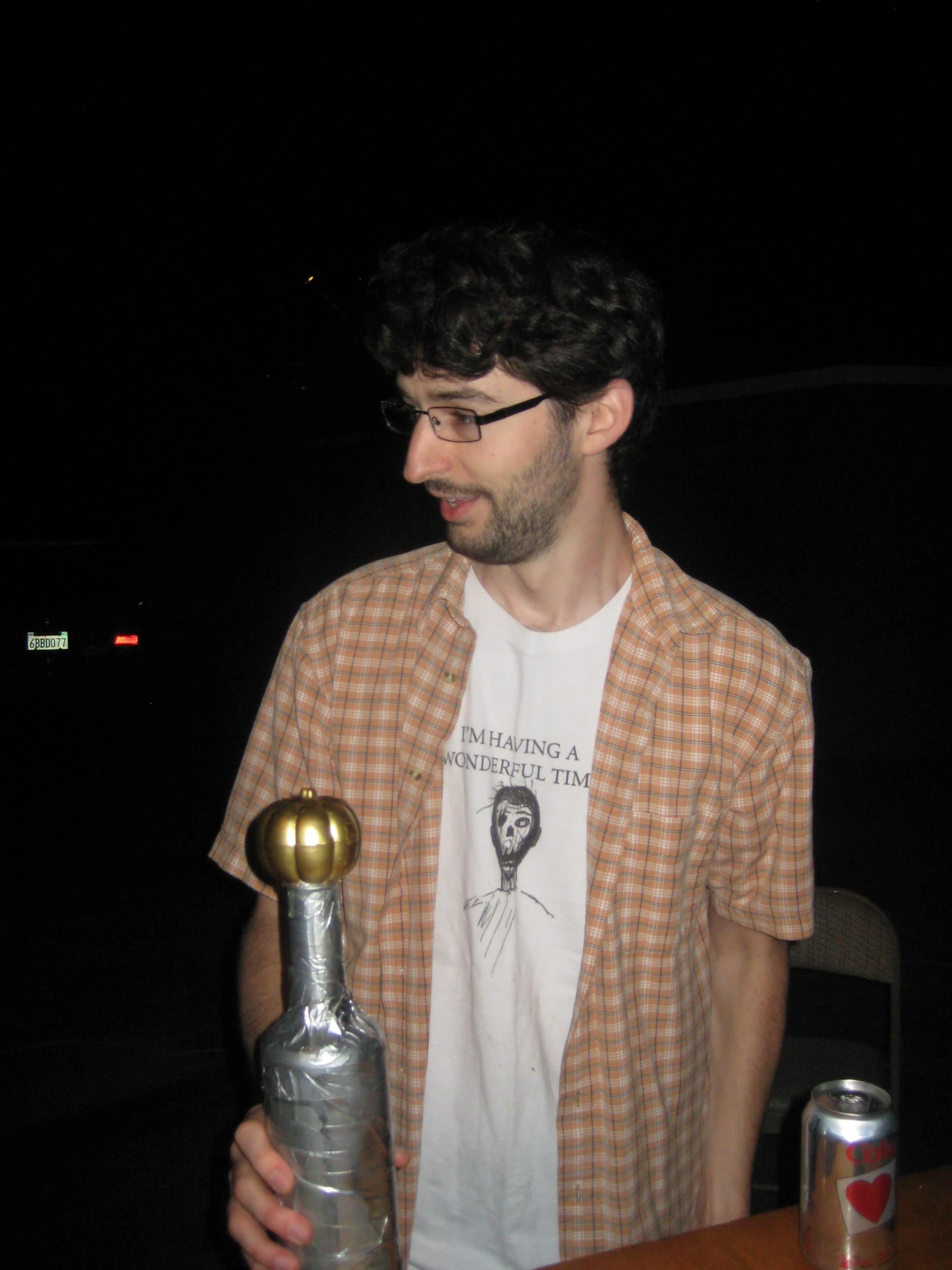 a man with glasses holding a beer bottle