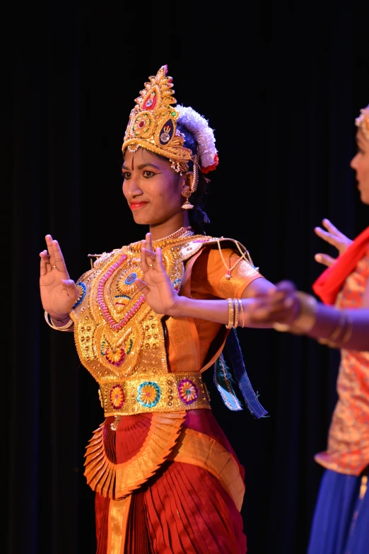 two dancers in costume in front of a microphone