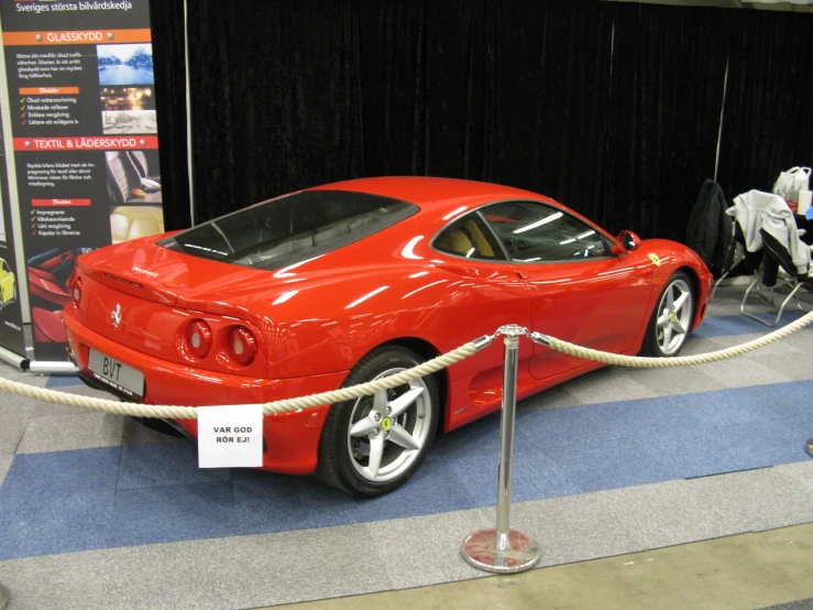 a red sports car with a rope around it