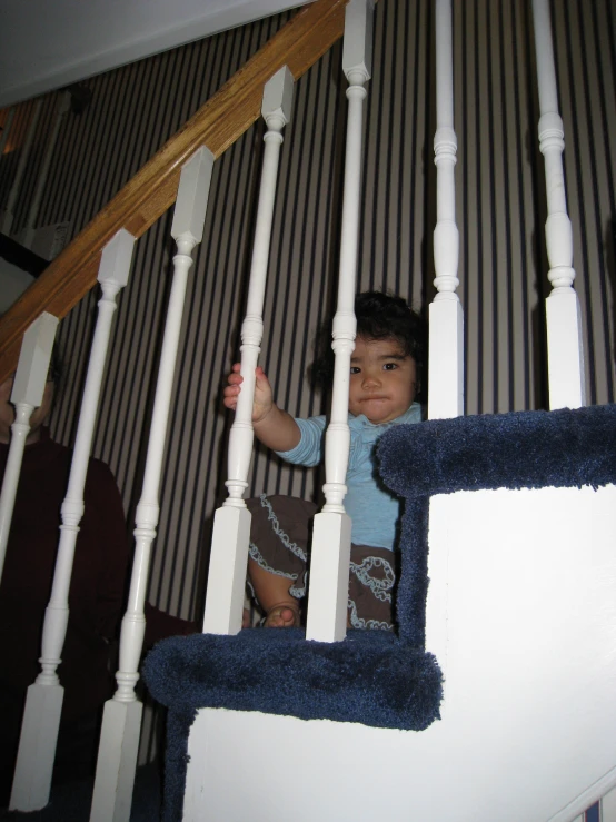 a child is looking up at the stair