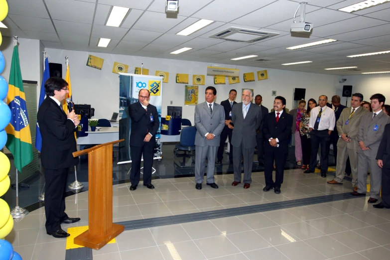 there are men standing in an office meeting