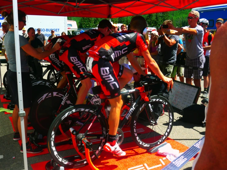 cyclist changing tires on a bicycle at a bicyclist event