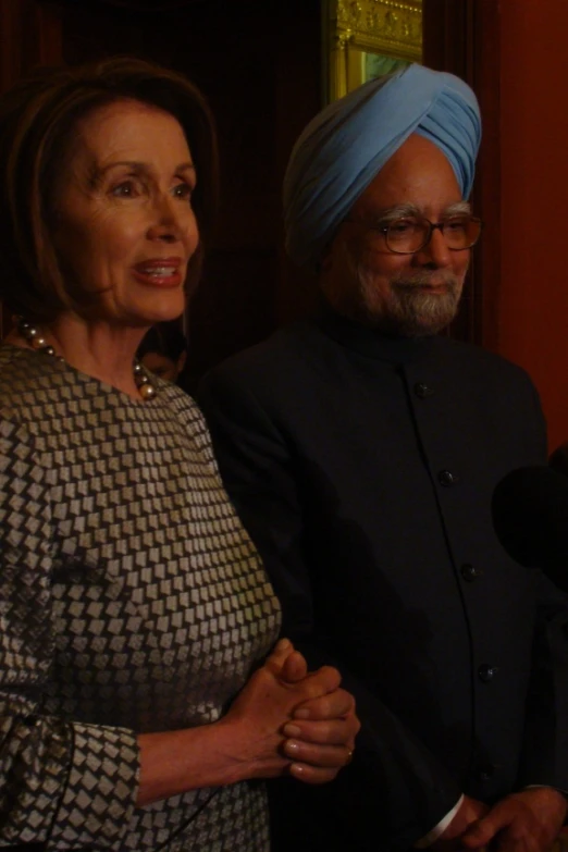 there is an older woman and young man with a turban