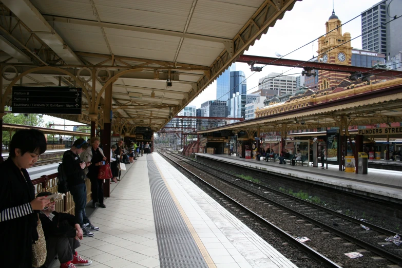 a group of people waiting at a train station