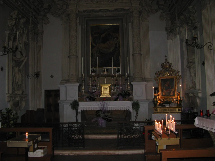 candles lit up in the front of a church