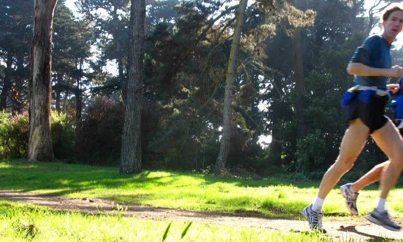 the woman is running in the forest on her skateboard