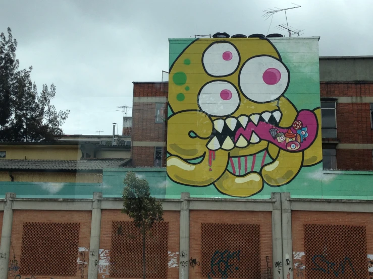 graffiti art depicting a monster with fangs and a large teeth