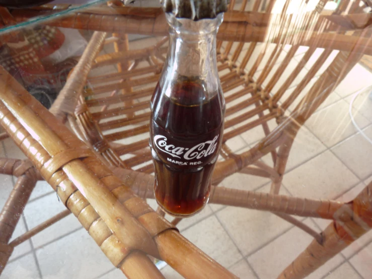 a bottle sitting on top of a wicker table