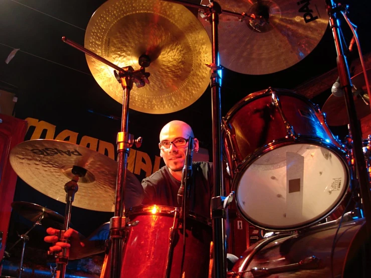 a drummer playing with his drums in the dark