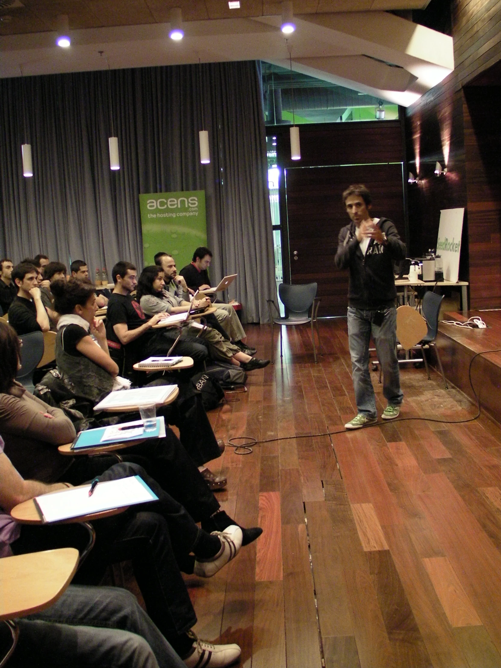 the young man stands in front of a class