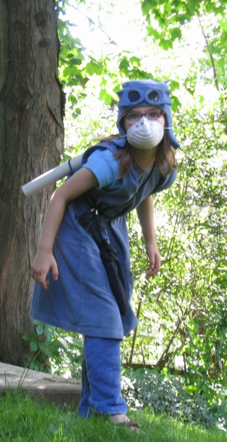 a girl is wearing a mask as a baseball bat