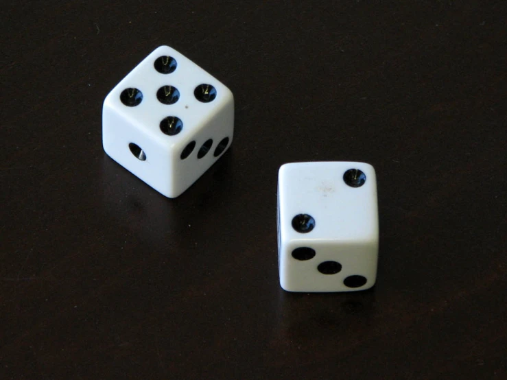 two white dices sitting next to each other on a table