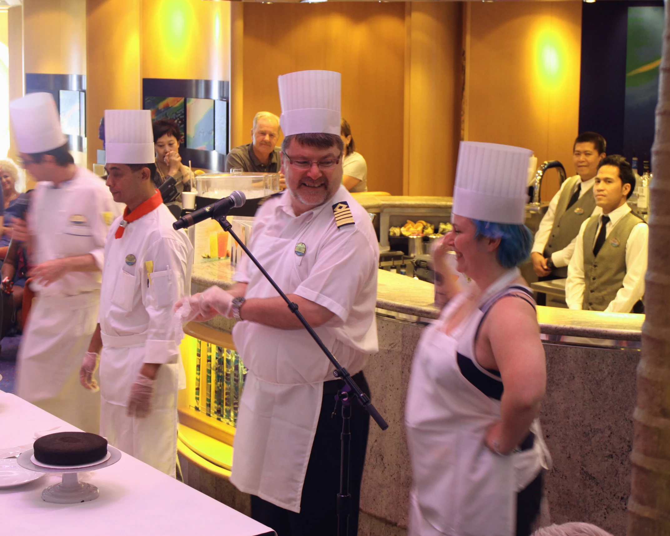 a chef is speaking to people in chefs'hats