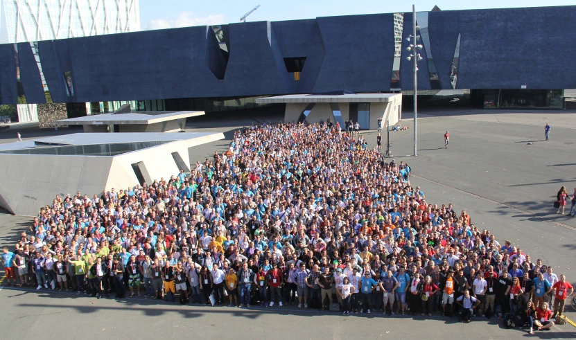 a large group of people standing in front of a building