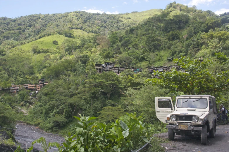 a small pick up truck parked on the side of a hill